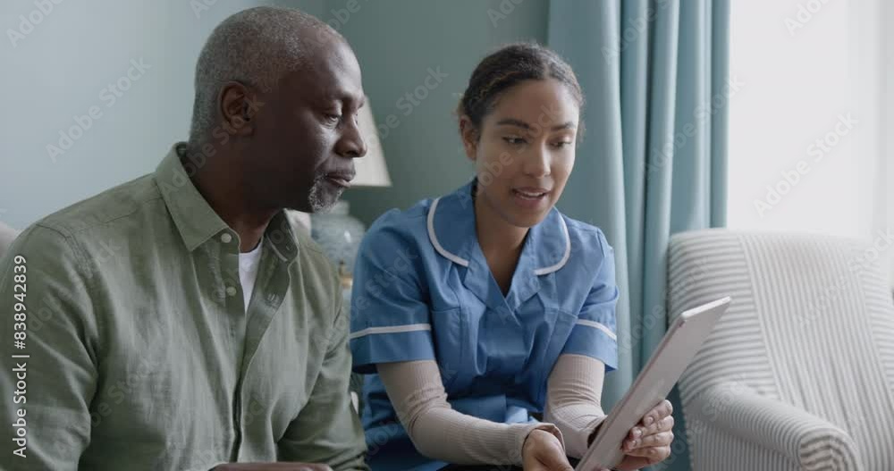Nurse showing Patient Health results using a Digital tablet on a Home visit Nurse showing Patient Health results using a Digital tablet on a Home visit