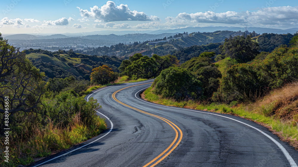 Scenic daytime view of curving asphalt road leading to city Scenic daytime view of curving asphalt road leading to city