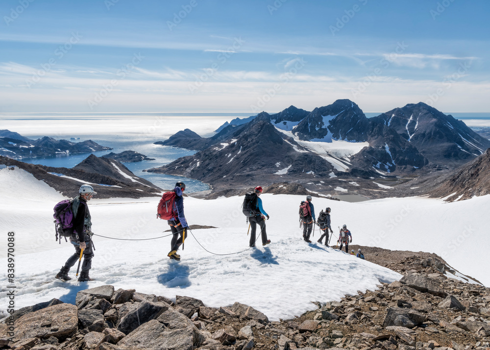 Greenland, Sermersooq, Kulusuk, Schweizerland Alps, group of people walking in snow