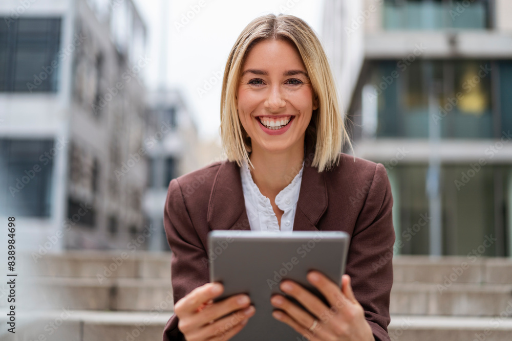 Portrait of happy young businesswoman using tablet in the city Portrait of happy young businesswoman using tablet in the city