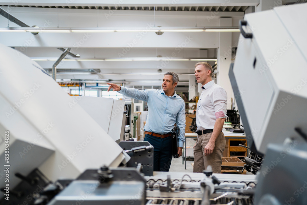 Two colleagues talking in a factory