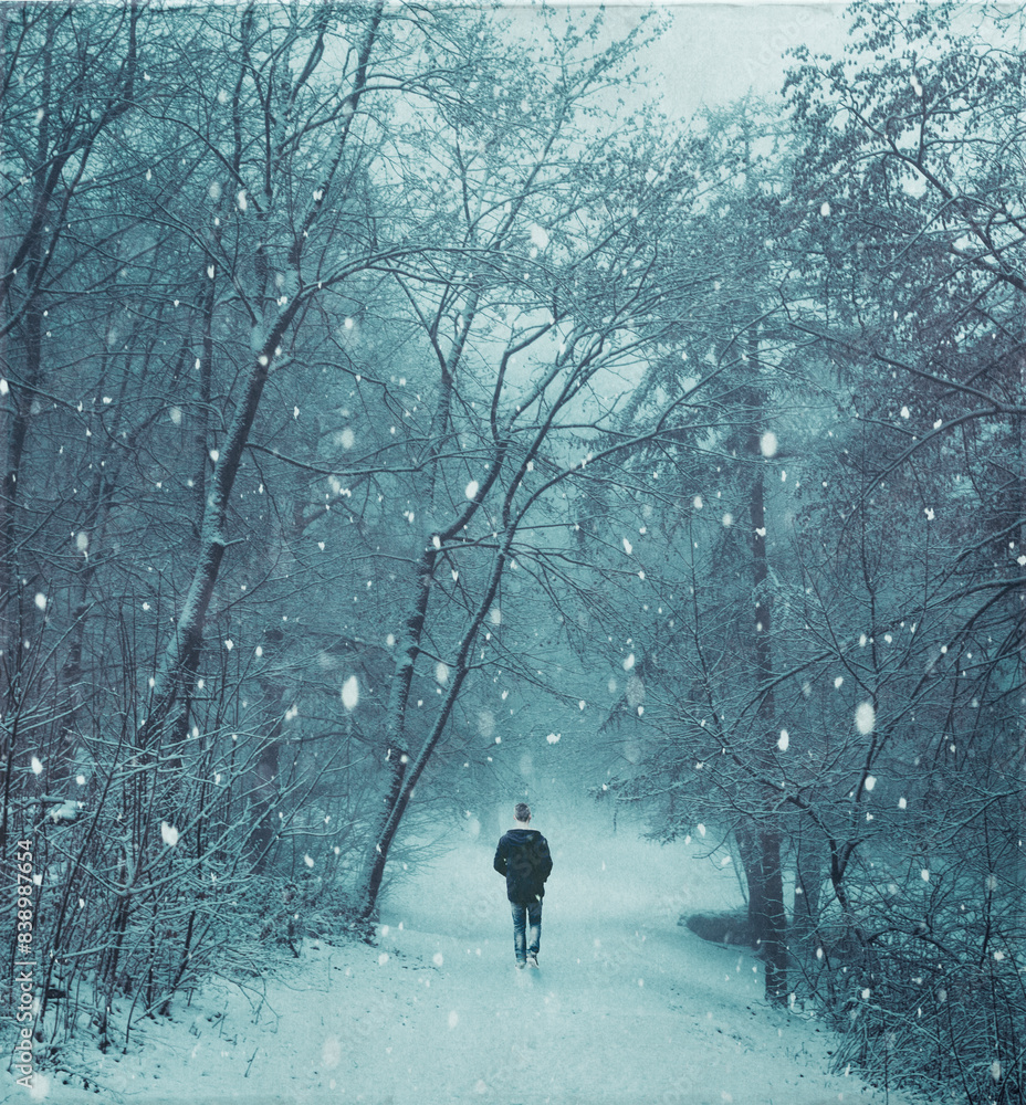 Man walking in snow storm at forest Man walking in snow storm at forest