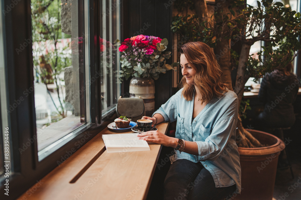 Young woman reading a book in a cafe Young woman reading a book in a cafe