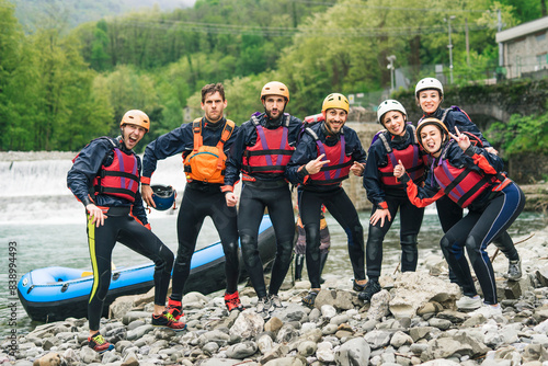 Фототапет Group of playful friends at a rafting class posing at boat