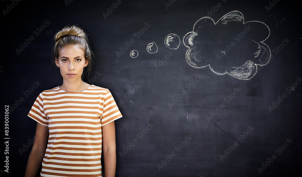 Pensive young woman standing in front of a blackboard next to a thought bubble Pensive young woman standing in front of a blackboard next to a thought bubble