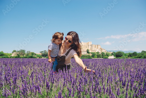 France, Grignan, mother and little daughter having fun together in lavender field photo