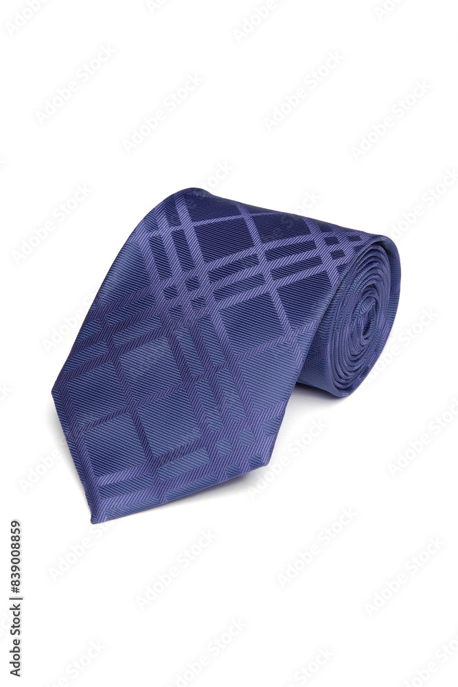 Close-up shot of an elegant blue tie embossed with a geometric pattern. The patterned blue tie is rolled and isolated on a white background. Top view. Close-up shot of an elegant blue tie embossed with a geometric pattern. The patterned blue tie is rolled and isolated on a white background. Top view.