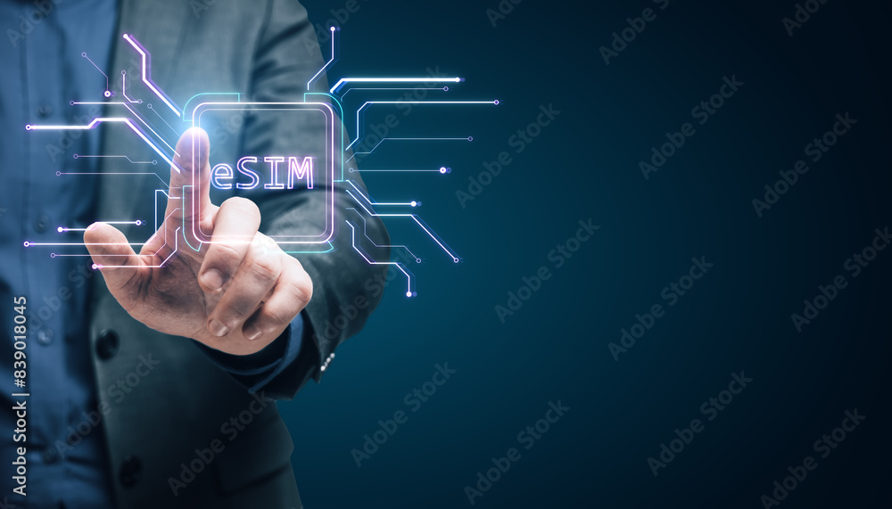 Close up of male hand pointing at creative glowing eSim hologram on blurry background with mock up place. Embedded sim and cellular mobile technology concept. Close up of male hand pointing at creative glowing eSim hologram on blurry background with mock up place. Embedded sim and cellular mobile technology concept.
