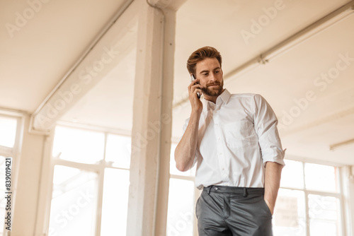 Portrait of young businessman on the phone in a loft