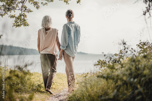 Mother and daughte holding hands at the photo