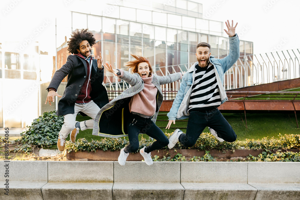 Three happy friends jumping in the city Three happy friends jumping in the city