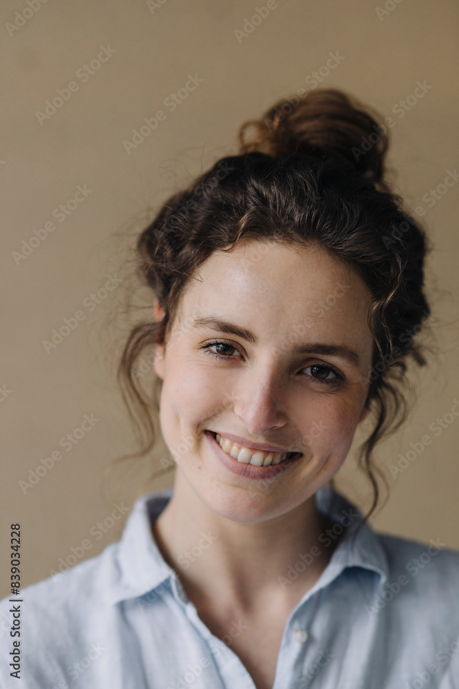 Portrait of smiling young woman with bun Portrait of smiling young woman with bun