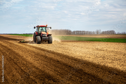 Obraz na płótnie Farmer in tractor plowing field in spring w salonie