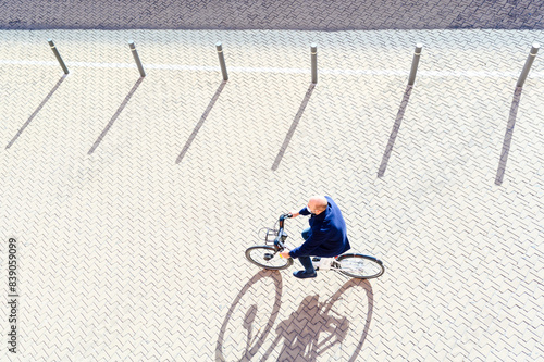 Mature man cycling on sunny day during pandemic illness