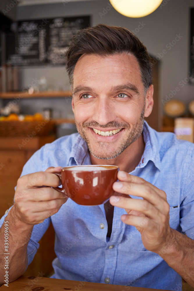 Portrait of laughing man with cup of coffee in a coffee shop Portrait of laughing man with cup of coffee in a coffee shop