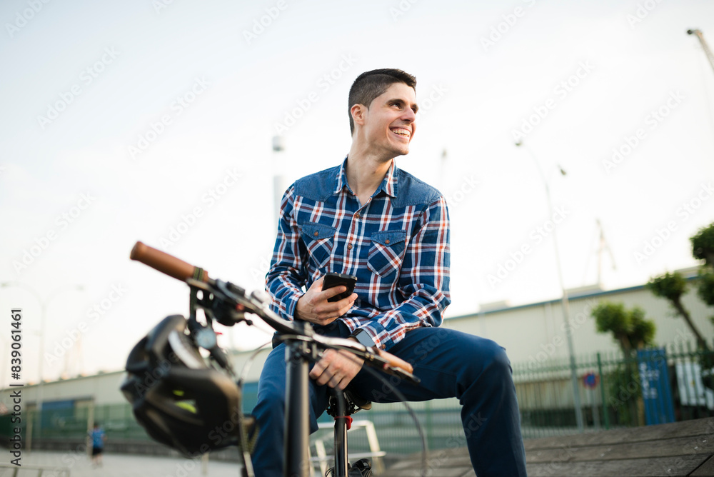 Happy young man with bicycle and cell phone Happy young man with bicycle and cell phone