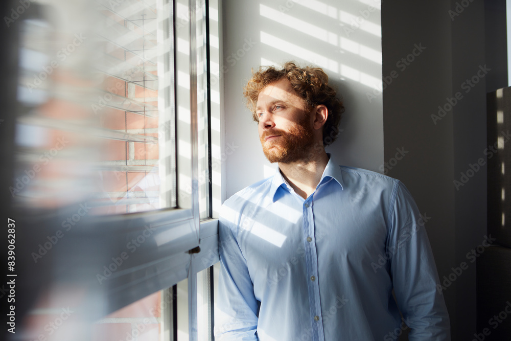 Portrait of businessman looking out of window