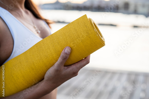 Wallpaper Mural Asian woman holding yoga mat at harbour at sunset Torontodigital.ca