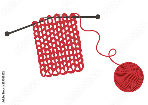 Ball of red wool and knitting needles