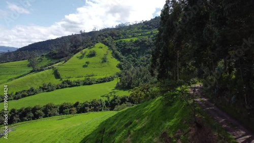 Aerial Drone Flyover Steep Roadside Along Green Foothill Farms And Forests On The Pasochoa volcano, Puichig, Machachi valley, Canton Mejia, Pichincha Province, Ecuador