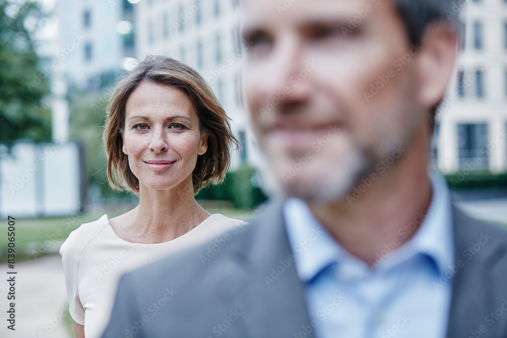 Portrait of confident businesswoman and businessman outdoors