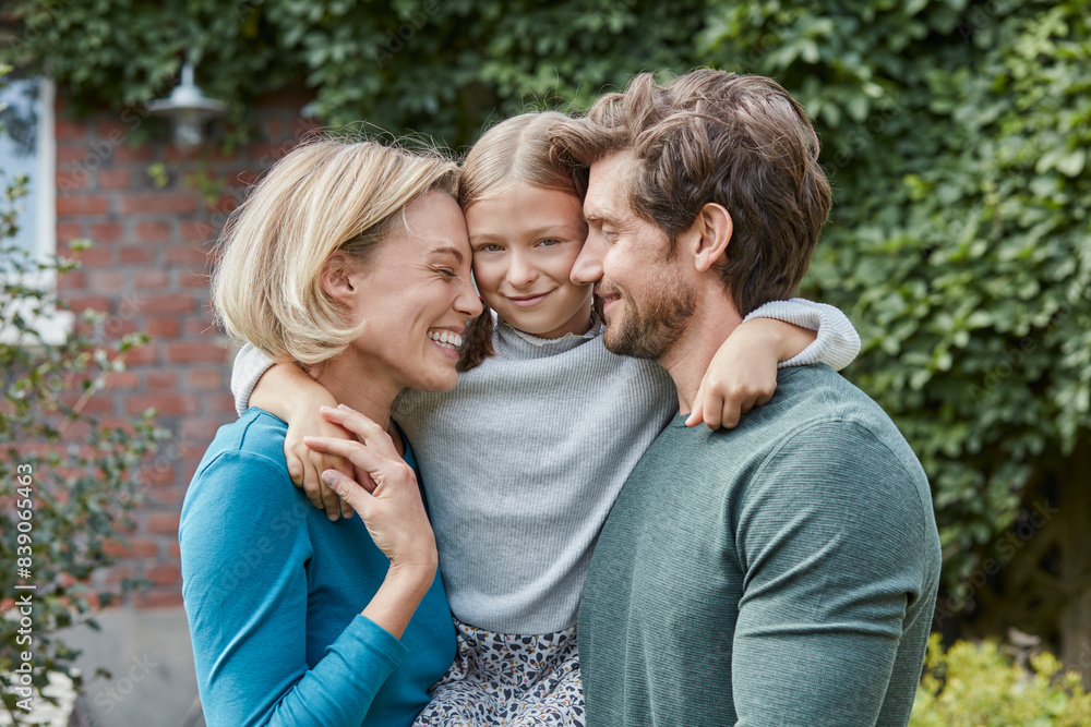 Portrait of happy family in garden of their home Portrait of happy family in garden of their home