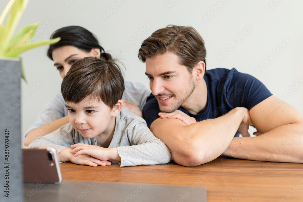 Family at home looking at cell phone Family at home looking at cell phone