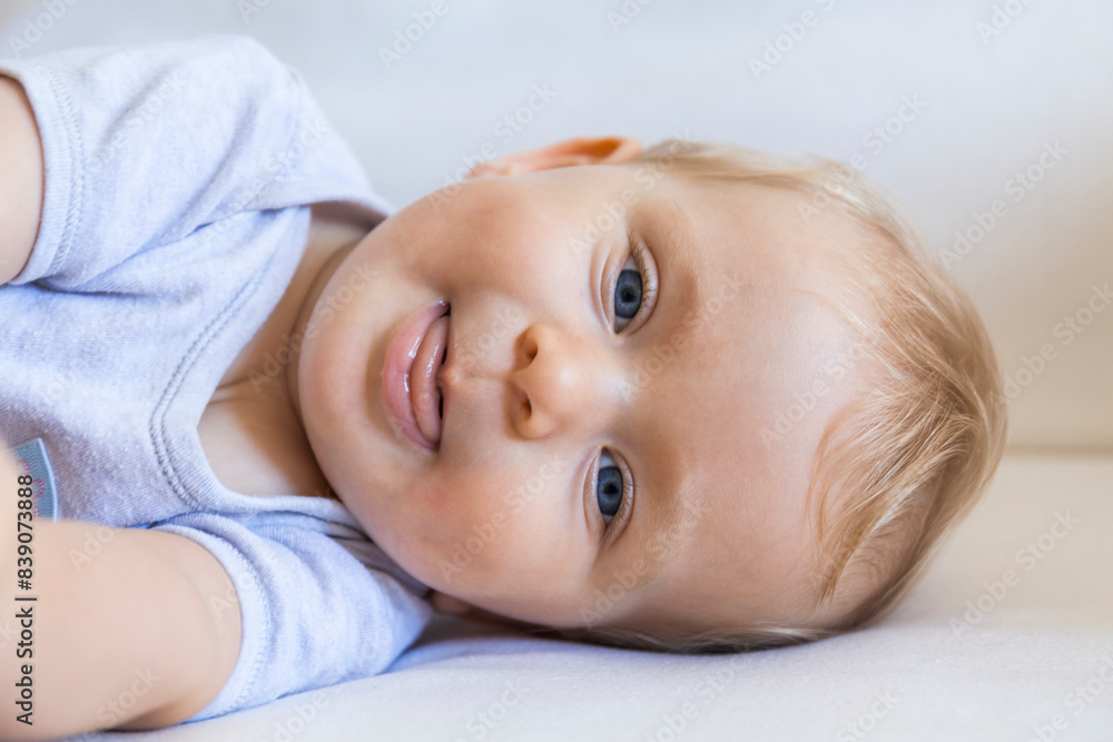 Portrait of blond baby girl lying on couch Portrait of blond baby girl lying on couch