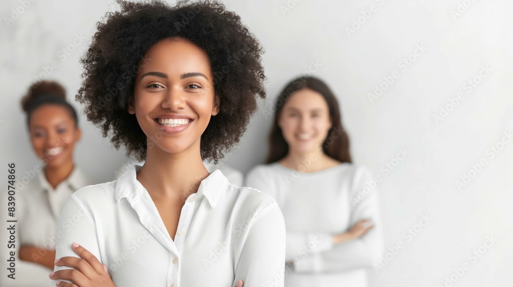 Smiling Businesswoman with Colleagues in Background - Teamwork and Success Concept Smiling Businesswoman with Colleagues in Background - Teamwork and Success Concept