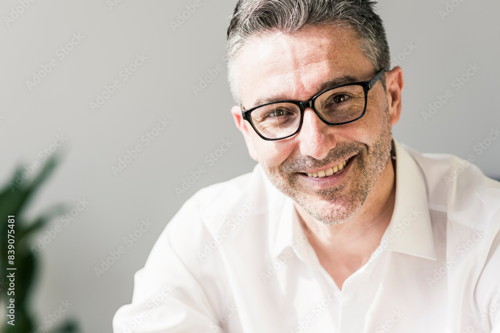 Portrait of smiling businessman with stubble wearing glasses Portrait of smiling businessman with stubble wearing glasses