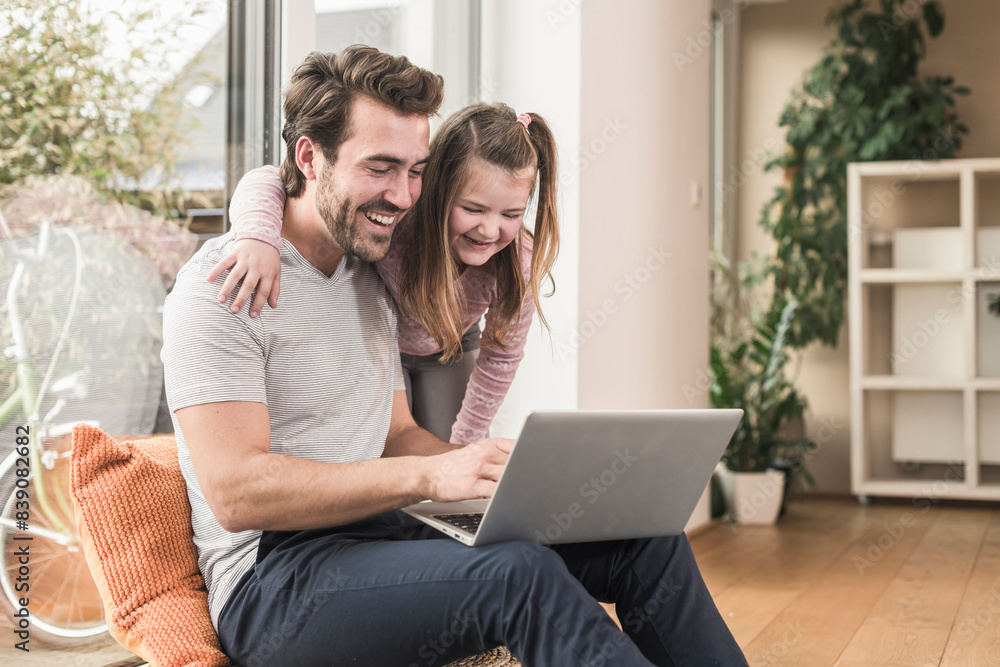 Young man and little girl surfing the net together Young man and little girl surfing the net together