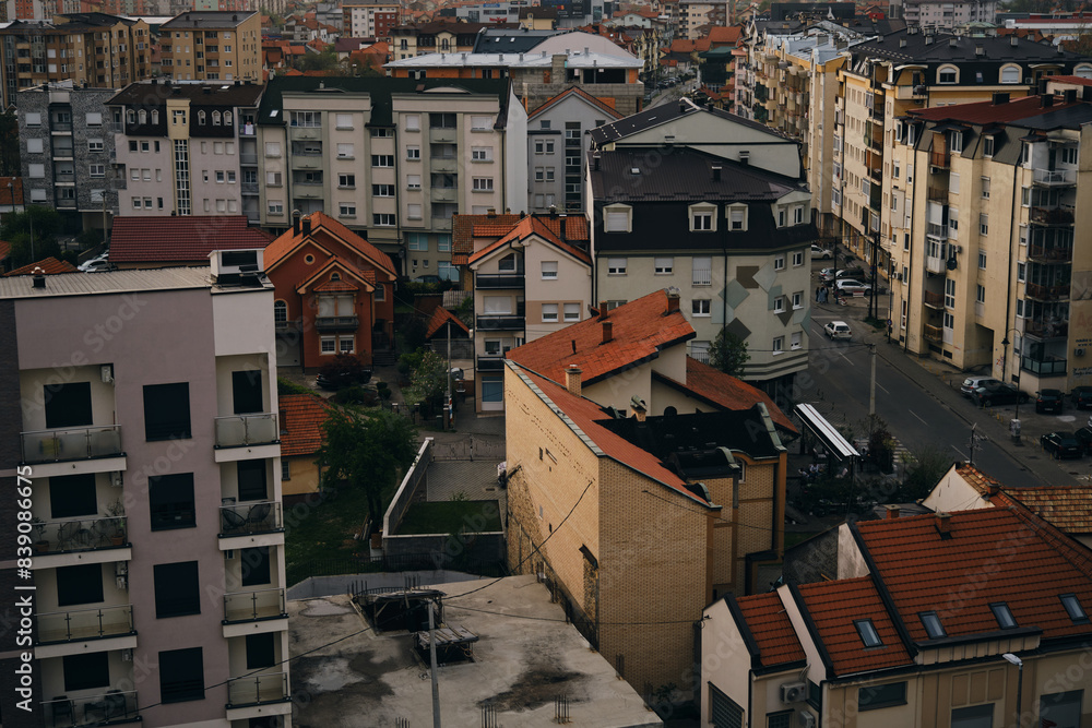 Fototapeta premium Scenic view sunset over the city Bijeljina, cityscape Bosnia and Herzegovina. Red tiled roofs of houses. View from above. A residential area of a small town.