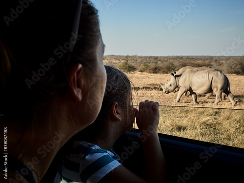 Mother and daughter admiring rhinoceroses through the car window, Mpumalanga, South Africa