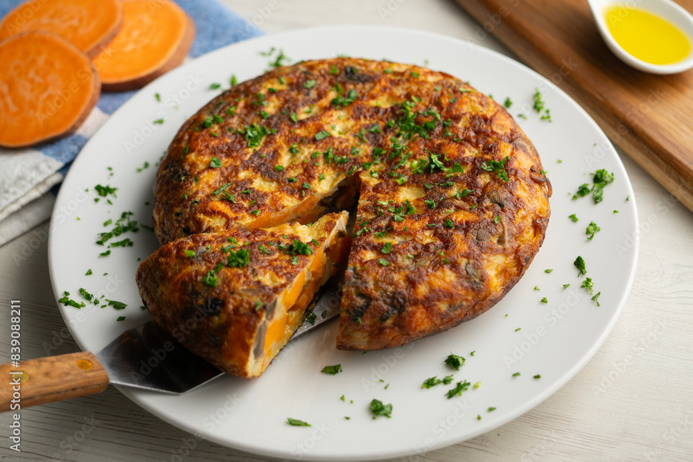 Spanish omelette with sweet potato, onion and egg. Traditional tapa of Spanish gastronomy. Spanish omelette with sweet potato, onion and egg. Traditional tapa of Spanish gastronomy.