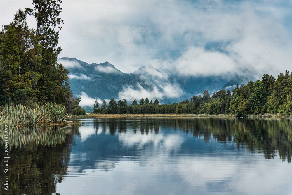 Lake Matheson glacier lake with mountain range and foggy reflection at New Zealand Lake Matheson glacier lake with mountain range and foggy reflection at New Zealand