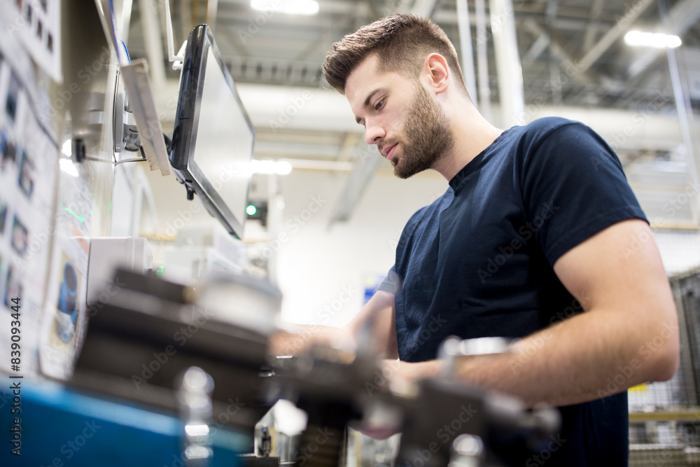 Man working in a modern factory operating a machine