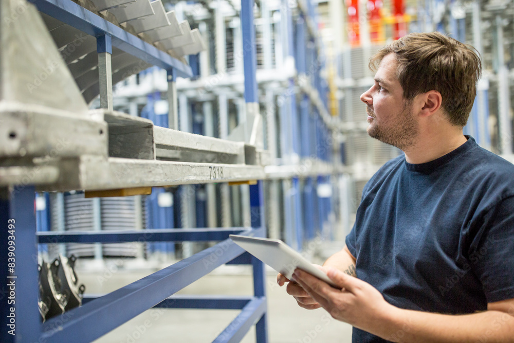 Worker using tablet in factory warehouse Worker using tablet in factory warehouse