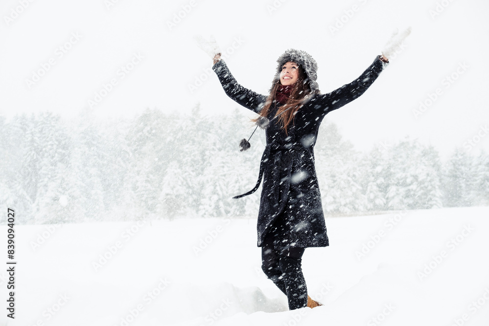 Portrait of happy young woman dancing in winter landscape Portrait of happy young woman dancing in winter landscape
