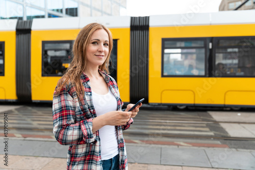 Portrait of a smiling woman in the city with a tram in the background, Berlin, Germany