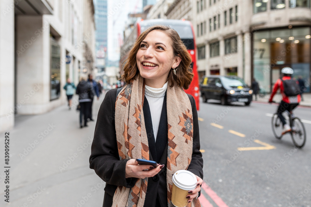Portrait of happy woman in the city, London, UK