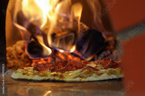 Close-up of delicious pizza being cooked in a burning oven