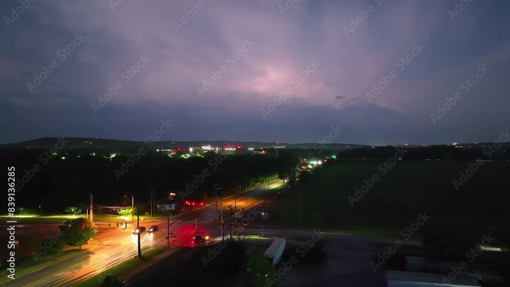 Lightning illuminates the night sky over a busy road in Springdale, Arkansas Lightning illuminates the night sky over a busy road in Springdale, Arkansas