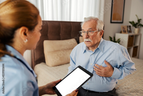 Senior man with heart problems having consultations with family doctor at home checkup and visit.