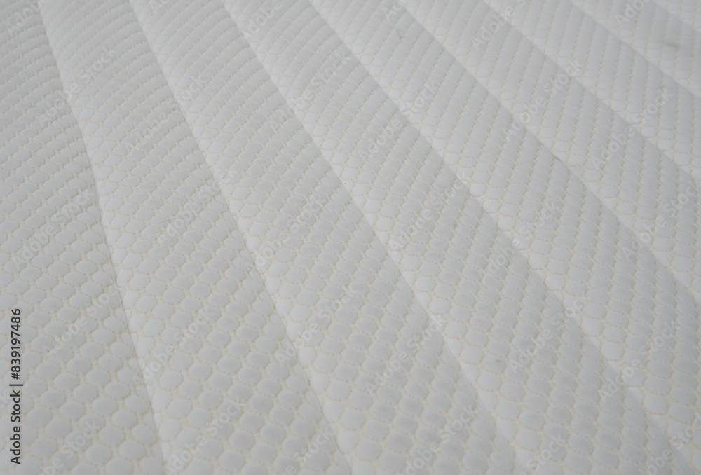 Fototapeta premium A white bed with a white sheet