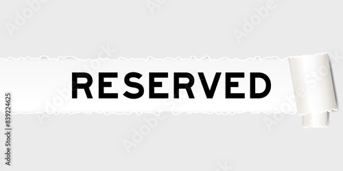 Ripped gray paper background that have word reserved under torn part
