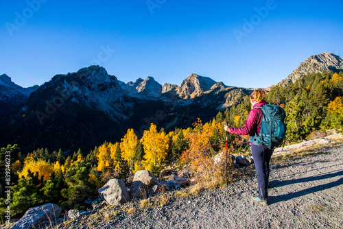Young hiker woman in autumn in Aiguestortes and Sant Maurici National Park, Spain photo