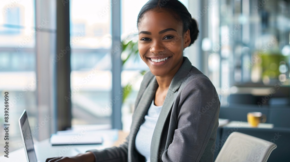 Confident Young Businesswoman Working on Laptop in Modern Office Environment Confident Young Businesswoman Working on Laptop in Modern Office Environment