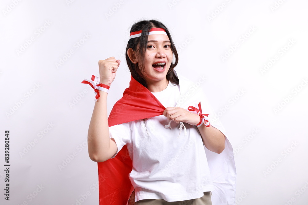 Young Asian woman clenched fist to celebrate Indonesia independence day on August 17, looking at camera with confident and excited expression isolated on white background Young Asian woman clenched fist to celebrate Indonesia independence day on August 17, looking at camera with confident and excited expression isolated on white background