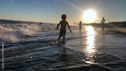 Little boy at the beach playing  silhouette