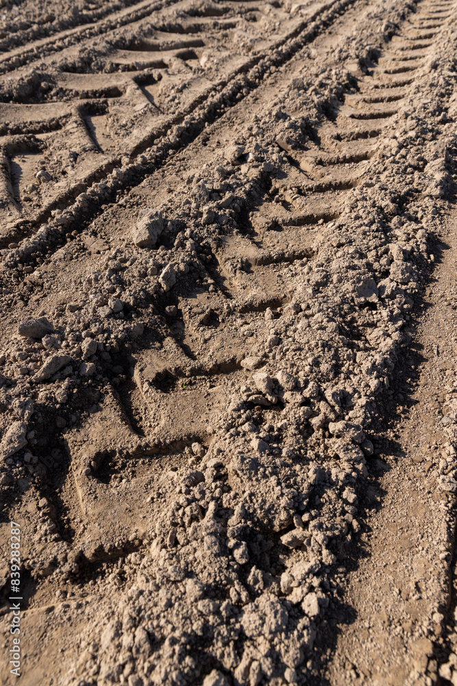 a plowed agricultural field with traces of a tractor a plowed agricultural field with traces of a tractor